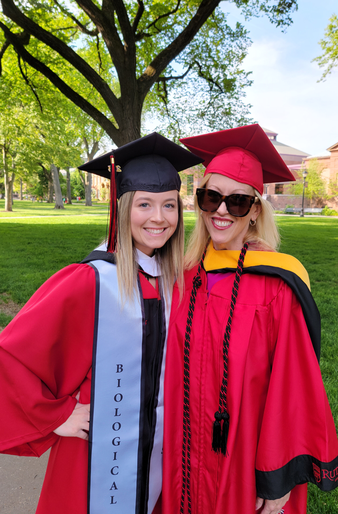 Regina Whittick, on right, and her daughter Charlotte wear red caps and gowns at Rutgers graduation.